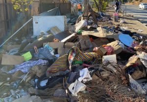 freeway off ramp covered in trash